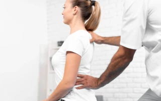 Male Physiotherapist Checking Woman S Back
