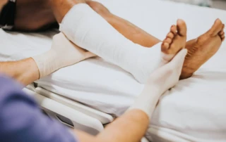 Resize Doctor Helping Patient With Fractured Leg