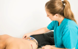 Resize Female Physical Therapist Positioning Electrodes Customer Lower Back Muscle Treatment Clinic