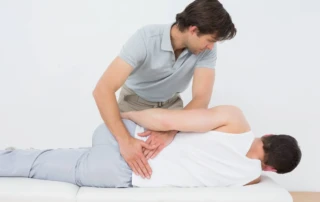 Resize Male Physiotherapist Examining Mans Back