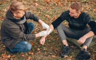 Resize Providing First Aid Park Man Bandaged Injured Arm Guy Helps Friend