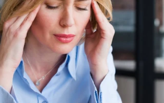 Resize Stressed Blond Business Woman Holding Head