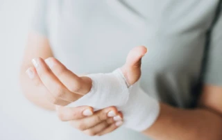 Resize Woman With Gauze Bandage Wrapped Around Her Hand